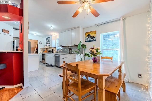 dining room featuring a ceiling fan, lofted ceiling, and light tile patterned floors