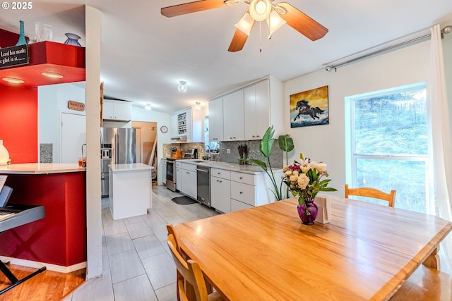 dining area with ceiling fan and vaulted ceiling