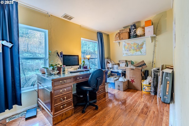 office with visible vents and wood finished floors