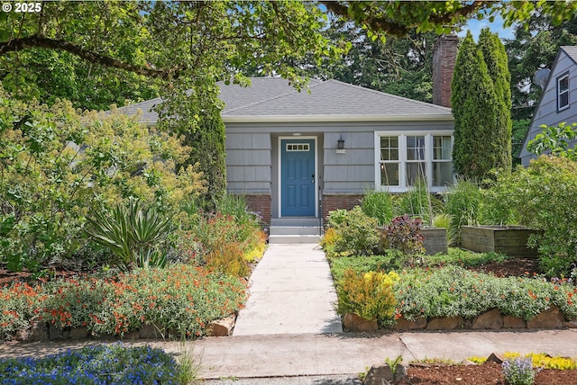 6134 NE 25th Ave, Portland, OR 97211 - bungalow-style house featuring a chimney, brick siding, and a shingled roof