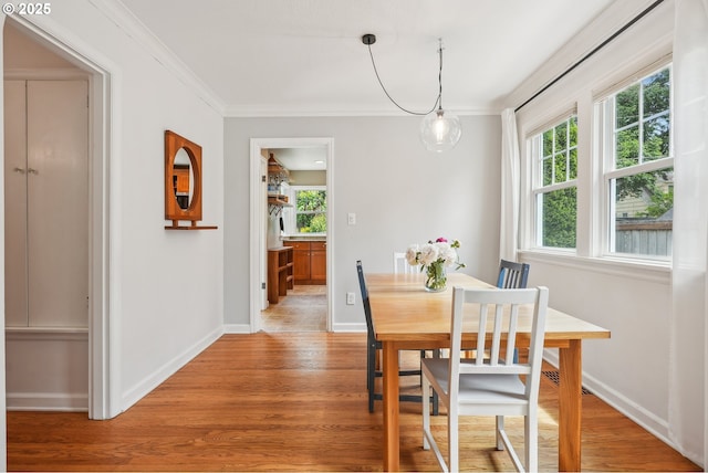 6134 NE 25th Ave, Portland, OR 97211 - dining area featuring light wood-style flooring, ornamental molding, and baseboards