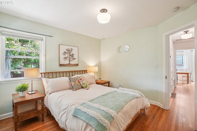 6134 NE 25th Ave, Portland, OR 97211 - bedroom with wood finished floors, multiple windows, and baseboards