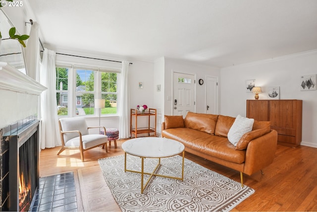 6134 NE 25th Ave, Portland, OR 97211 - living room featuring a fireplace, wood finished floors, and ornamental molding