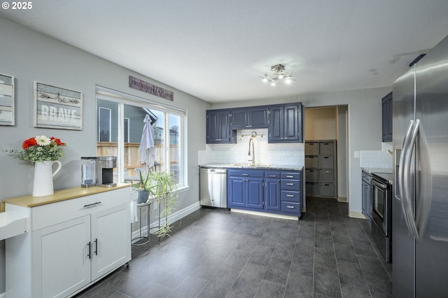 2550 NE Aaron Dr, Mcminnville, OR 97128 - kitchen with stainless steel appliances, tasteful backsplash, blue cabinetry, and a sink