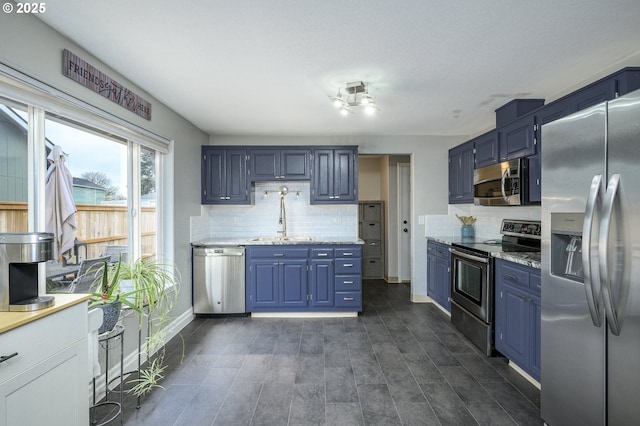 2550 NE Aaron Dr, Mcminnville, OR 97128 - kitchen with stainless steel appliances, tasteful backsplash, a sink, and blue cabinets