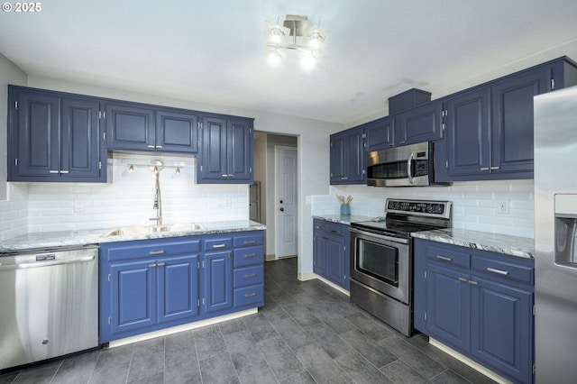 2550 NE Aaron Dr, Mcminnville, OR 97128 - kitchen featuring appliances with stainless steel finishes, blue cabinetry, backsplash, and light stone countertops