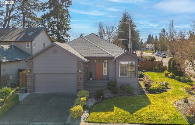 view of front of property featuring an attached garage, driveway, fence, and brick siding