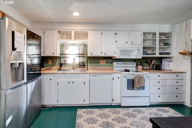 kitchen featuring white cabinetry, sink, and white appliances