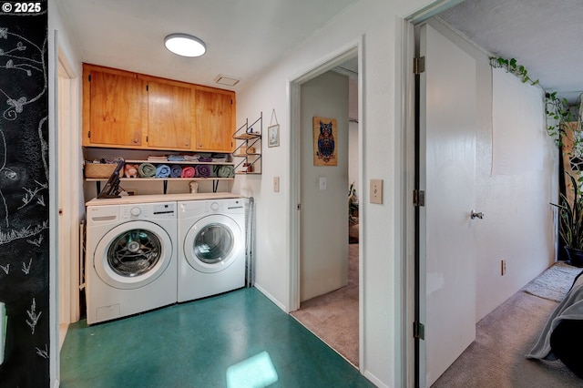 laundry room featuring cabinets and washing machine and clothes dryer