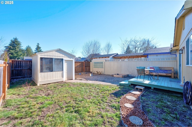 view of yard featuring a storage shed and a deck