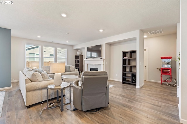 1939 Branch Creek Dr, Longview, WA 98632 - living room featuring a fireplace, light wood-style flooring, and recessed lighting