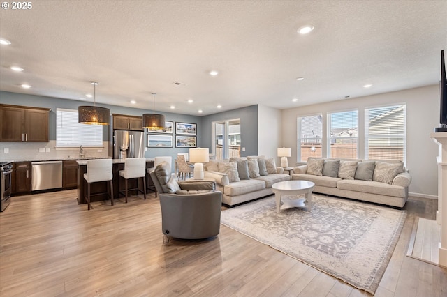 1939 Branch Creek Dr, Longview, WA 98632 - living room featuring light wood-style flooring, recessed lighting, and a textured ceiling