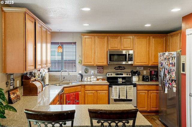 216 Churchill Downs St, Albany, OR 97322 - kitchen with appliances with stainless steel finishes, a peninsula, pendant lighting, recessed lighting, and dark wood-style flooring