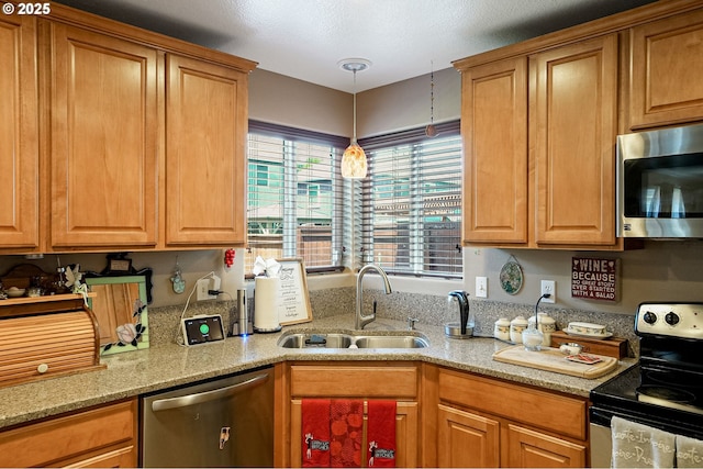216 Churchill Downs St, Albany, OR 97322 - kitchen with appliances with stainless steel finishes, light stone countertops, pendant lighting, and brown cabinetry