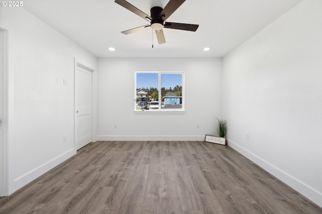 empty room featuring wood finished floors, a ceiling fan, baseboards, and recessed lighting
