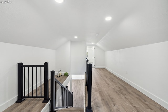 bonus room featuring light wood-style flooring, baseboards, vaulted ceiling, and recessed lighting