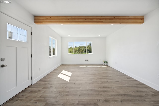 foyer entrance featuring beam ceiling, baseboards, wood finished floors, and recessed lighting