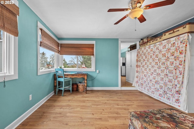 office with a ceiling fan, light wood-style flooring, and baseboards