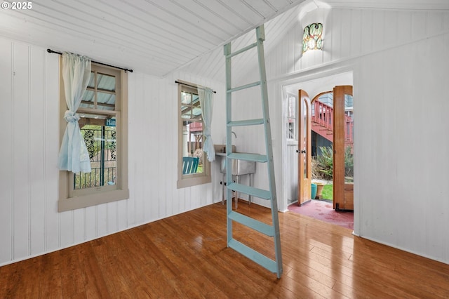 spare room featuring vaulted ceiling and wood finished floors