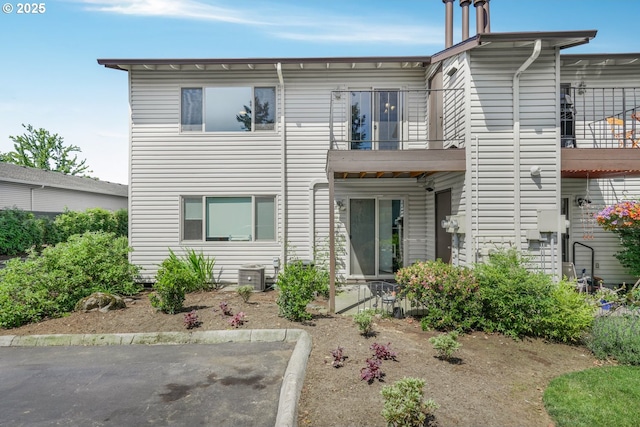 12510 SE Stark St Unit H, Portland, OR 97233 - view of front of property with a balcony, a patio area, and central AC