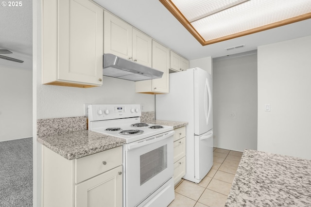 12510 SE Stark St Unit H, Portland, OR 97233 - kitchen with under cabinet range hood, white appliances, light tile patterned flooring, and white cabinets
