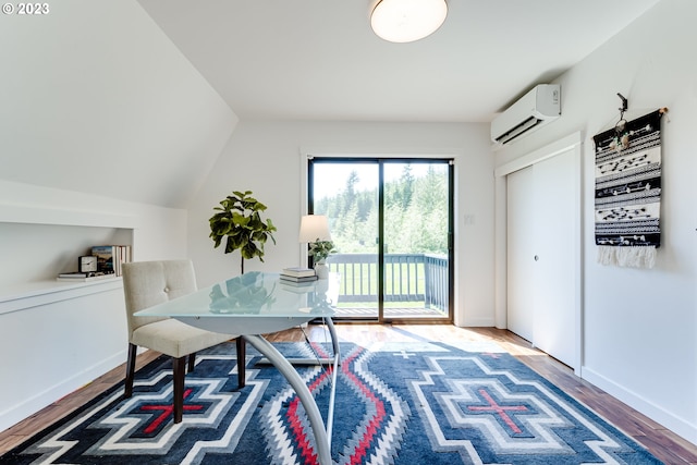 office area featuring baseboards, a wall unit AC, and wood finished floors