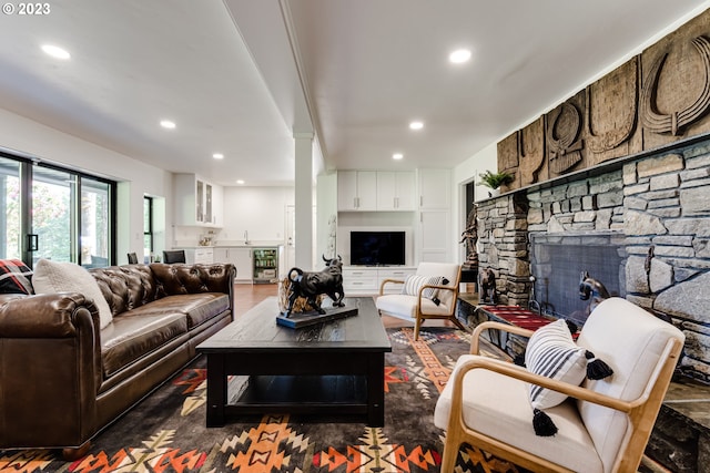 living room with recessed lighting, wine cooler, and a fireplace