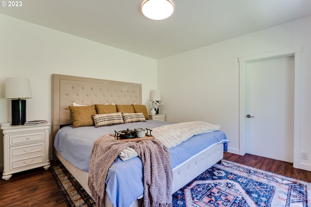 bedroom featuring dark wood finished floors