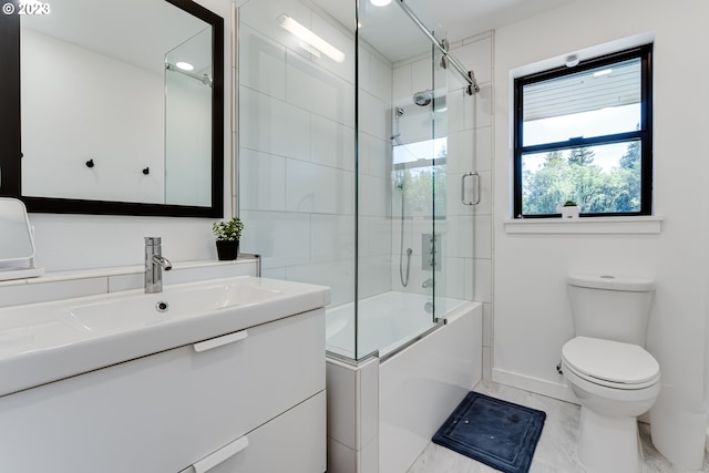 bathroom with toilet, marble finish floor, shower / bath combination with glass door, baseboards, and vanity