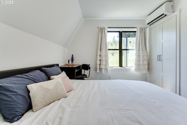 bedroom featuring vaulted ceiling and a wall mounted air conditioner