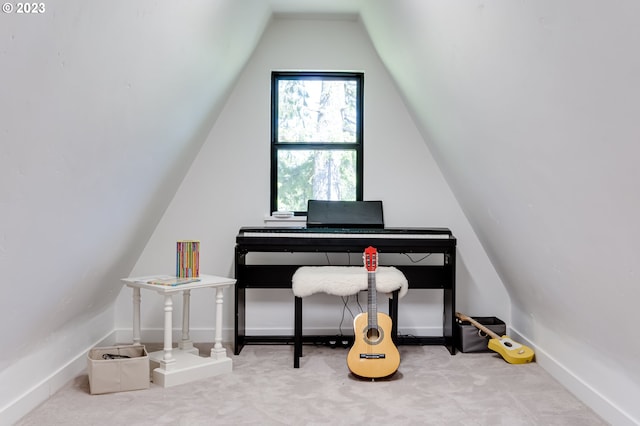 office area featuring carpet flooring, lofted ceiling, and baseboards