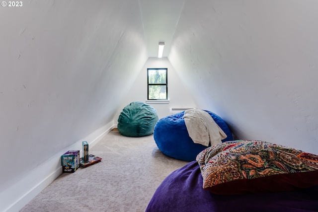 bedroom featuring baseboards, carpet floors, and vaulted ceiling