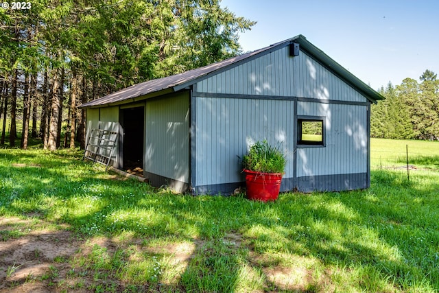 view of pole building with a yard and fence