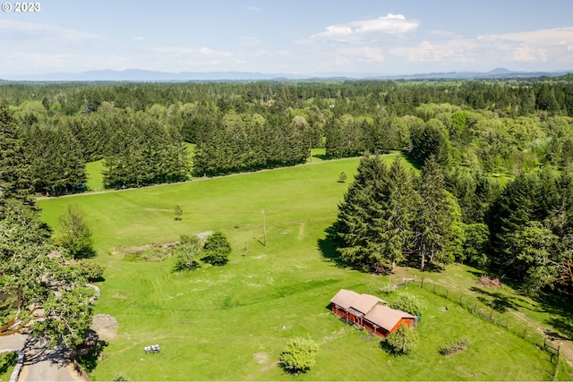 birds eye view of property with a rural view and a wooded view