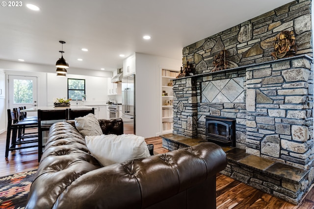 living area with dark wood finished floors, recessed lighting, and a fireplace