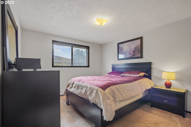 carpeted bedroom featuring a textured ceiling