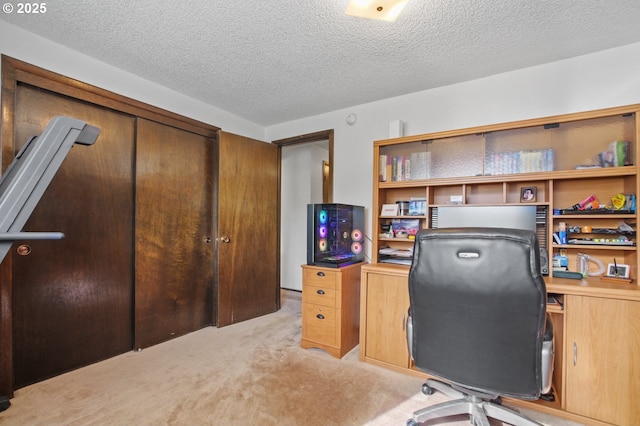 home office with light carpet and a textured ceiling