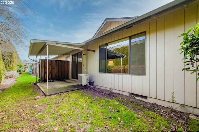 view of property exterior with a lawn and a patio