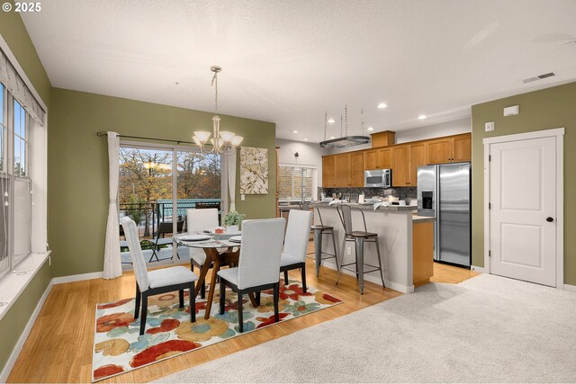 8844 NE Brentford Way, Hillsboro, OR 97006 - dining room with a chandelier, light wood-type flooring, baseboards, and recessed lighting