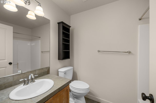 8844 NE Brentford Way, Hillsboro, OR 97006 - bathroom with vanity, a shower, toilet, and tasteful backsplash