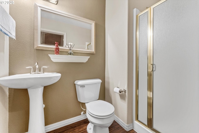 2462 NE 11th Ave, Hillsboro, OR 97124 - full bathroom featuring wood finished floors, a stall shower, toilet, baseboards, and a sink