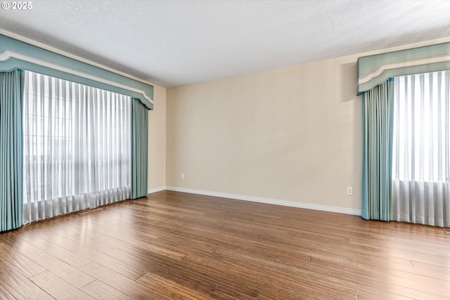 2462 NE 11th Ave, Hillsboro, OR 97124 - unfurnished room featuring wood finished floors, baseboards, and a textured ceiling