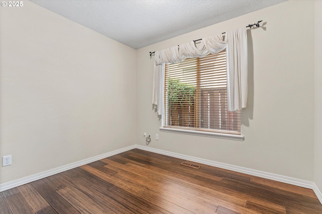 2462 NE 11th Ave, Hillsboro, OR 97124 - unfurnished room featuring baseboards, wood finished floors, and a textured ceiling