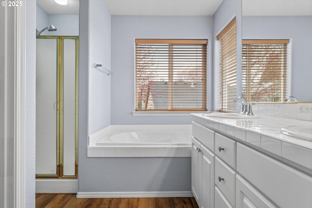 2462 NE 11th Ave, Hillsboro, OR 97124 - bathroom featuring wood finished floors, plenty of natural light, a shower stall, and double vanity