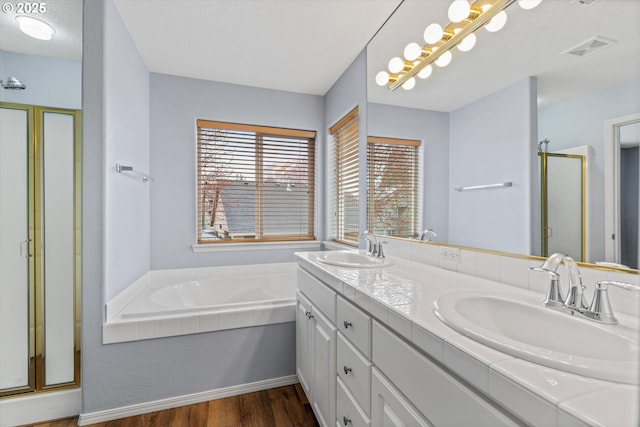 2462 NE 11th Ave, Hillsboro, OR 97124 - bathroom featuring wood finished floors, a stall shower, a bath, and double vanity