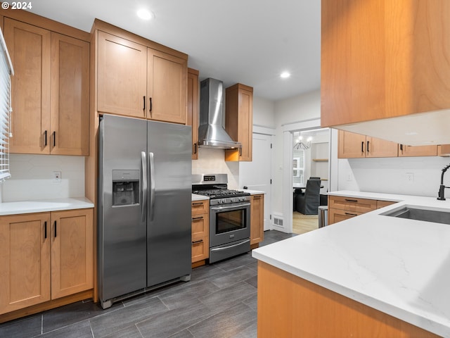 kitchen with appliances with stainless steel finishes, backsplash, sink, wall chimney range hood, and a notable chandelier