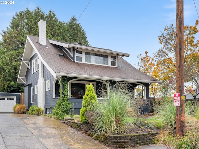 view of front facade featuring a garage and an outdoor structure