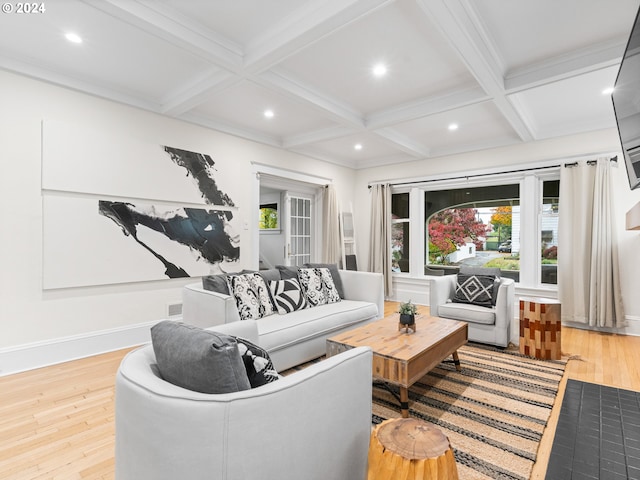 living room featuring beamed ceiling, light hardwood / wood-style floors, and coffered ceiling