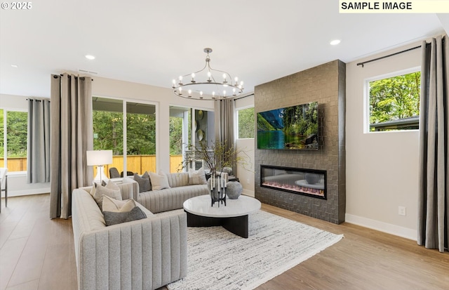 8705 S 4th Way, Ridgefield, WA 98642 - living room with plenty of natural light, baseboards, a chandelier, a large fireplace, and recessed lighting