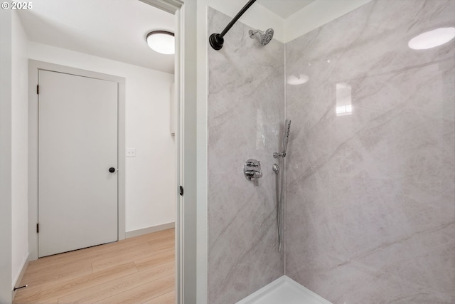 full bath with walk in shower and wood finished floors